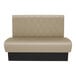 A tan leather booth with a diamond tufted back and black trim.