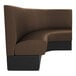 A brown curved cafe booth with black legs.