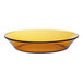A close up of a Duralex amber glass soup plate with a black rim.