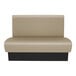 A tan and black double back booth with a black base.