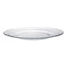 A Duralex clear glass dinner plate with a scalloped edge.