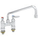 A T&S chrome deck-mounted faucet with swing nozzle and lever handles.