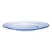 A clear glass plate with a wavy edge and a blue rim.