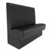 A black upholstered single back booth with a high backrest and plain design.