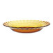 A Duralex amber glass plate with a scalloped edge and a yellow rim.