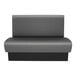 A grey and black bench with a black base.
