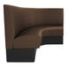 A brown leather curved corner booth with black base.