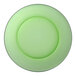 A green Duralex glass dinner plate with a black rim.