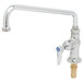 A silver deck-mount faucet with a metal handle and blue knob.