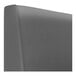 A graphite plain curved corner booth upholstered in grey leather.