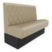 A tan leather booth with black legs.
