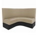 A tan and black 1/2 circle booth with black legs.