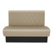A tan leather booth with a diamond tufted single back and black trim.
