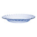 A clear glass plate with a scalloped edge.