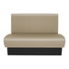 A tan and black bench with a black base.