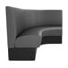 A graphite grey curved booth with black and grey upholstery.