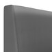 A close up of a graphite leather booth back.