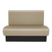 A tan and black bench with a black base.
