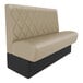A tan leather tufted single booth with black legs.