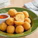 A plate of Simply Cuisine Mac and Cheese Bites with dipping sauce.