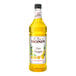A Monin Premium Pineapple Yuzu flavoring syrup bottle on a white background.