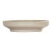 A taupe round coupe melamine bowl/plate with a plain white surface.