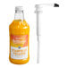 A close up of a Monin Brilliance Starfruit Yellow Energy Concentrate bottle with a white cap.