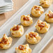 A tray of Simply Cuisine Caramelized Onion and Feta Cheese Tarts on a table.