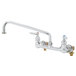 A chrome T&S wall mount pantry faucet with two handles.