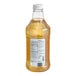 A close-up of a bottle of Monin Brilliance Sugar-Free Glacier Clear Energy Concentrate with a white cap.