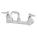 A chrome T&S wall mount pantry faucet with two silver knobs.