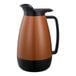 A copper and black Thermo-Serv coffee carafe with flip-top lid.