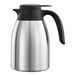 A silver stainless steel Service Ideas coffee carafe with a black handle.