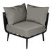 A BFM Seating Cayman outdoor corner chair with a Sunbrella charcoal cushion.
