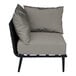 A BFM Seating Cayman black outdoor corner chair with a Sunbrella charcoal cushion.