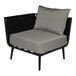 A BFM Seating black outdoor corner chair with a charcoal cushion.