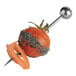 A tomato with cheese on a Solia silver plastic needle skewer.
