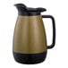 A black and gold coffee pot with a black handle.