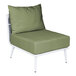 A white BFM Seating Cayman outdoor couch middle section with a Sunbrella fern cushion and back pillow on a green chair with white legs.