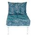 A BFM Seating Cayman white outdoor middle chair with a Sunbrella blue cushion and back pillow with white leaves on it.
