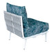 A white BFM Seating outdoor couch middle section with a blue cushion and pillow on it.