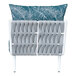 A white BFM Seating Cayman middle section chair with a blue and white Sunbrella cushion and back pillow.
