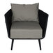 A BFM Seating Cayman black rope outdoor armchair with a Sunbrella charcoal cushion and back pillow.