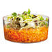 A Solia clear plastic short cup filled with beans and vegetables.