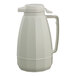 A white plastic coffee carafe with a lid and handle.