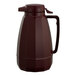A brown plastic Service Ideas coffee carafe with a handle.