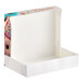 A white box with a picture of a donut inside.