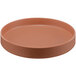 A brown round Cal-Mil Terra Cotta melamine plate with a raised rim.