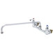 A chrome T&amp;S wall mounted pantry faucet with two long silver handles.