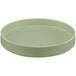 A round green Cal-Mil melamine plate with a raised rim on a white background.